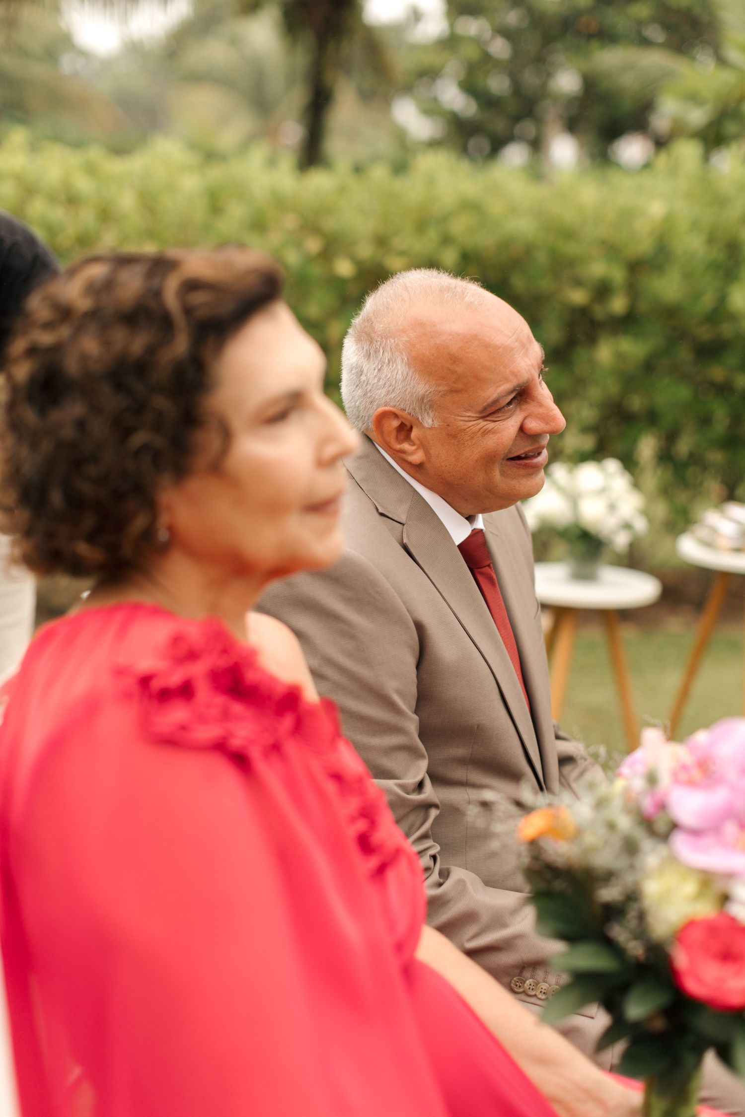 Wedding guests in formal attire enjoying the outdoor celebration.