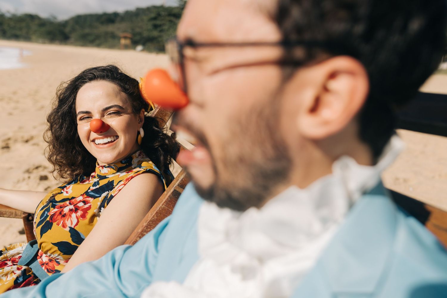 A cheerful couple enjoying a sunny day at the beach.