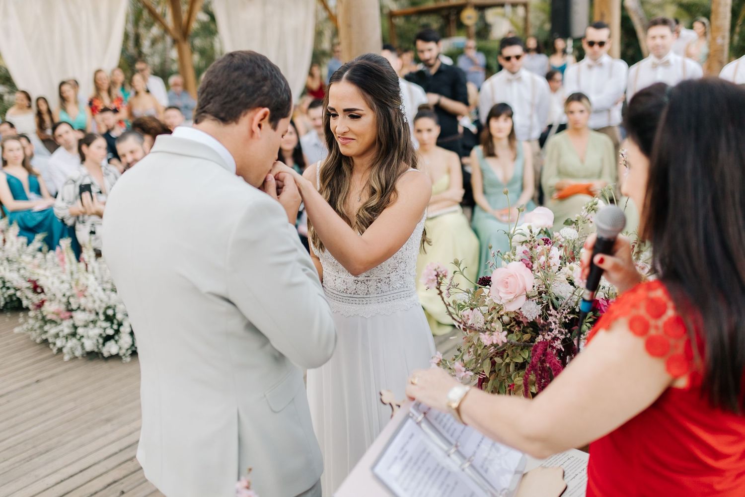 Intimate wedding ceremony moment between couple during outdoor garden celebration.