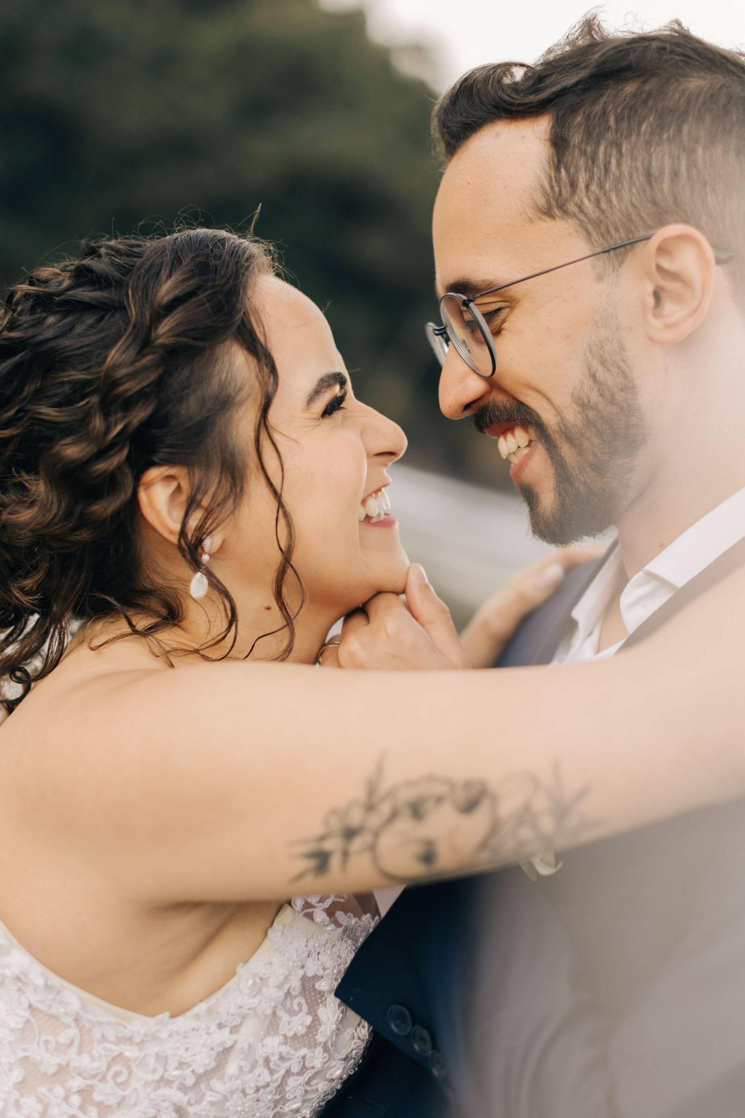 An intimate close-up moment between newlyweds sharing joyful laughter.