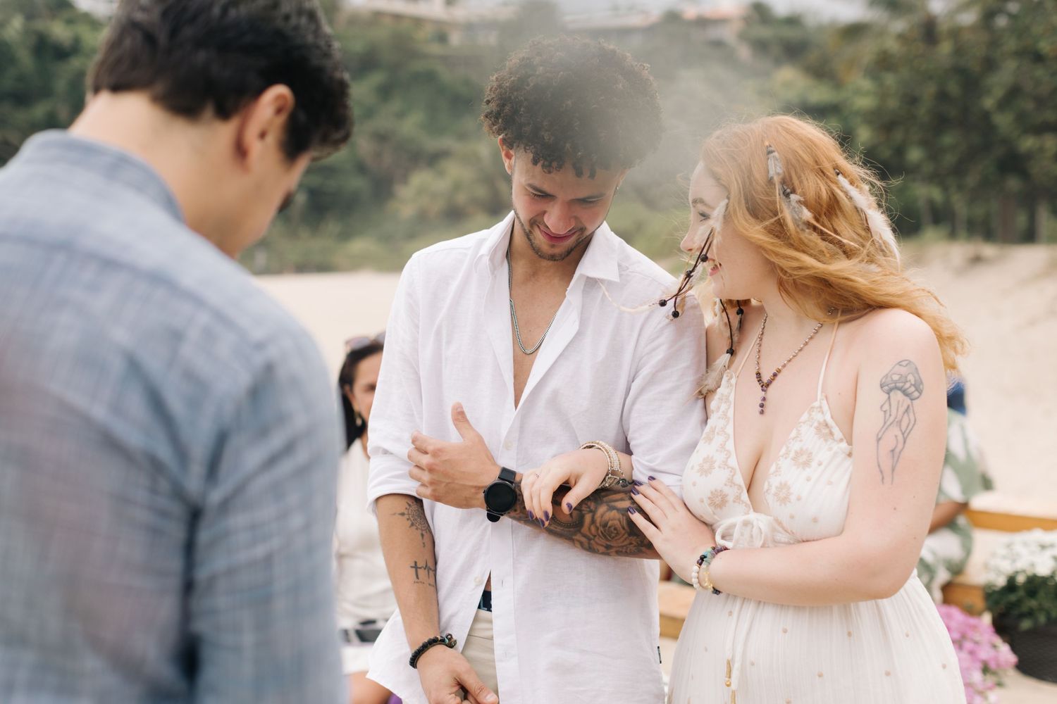 A couple shares a joyful moment during their beach wedding ceremony.