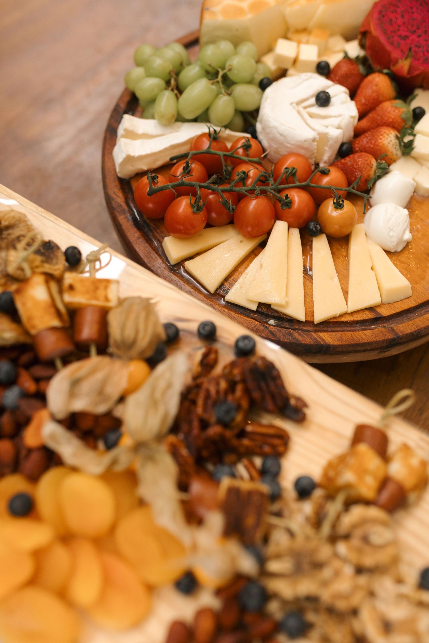 Elegant charcuterie board with assorted cheeses, fruits, and appetizers.