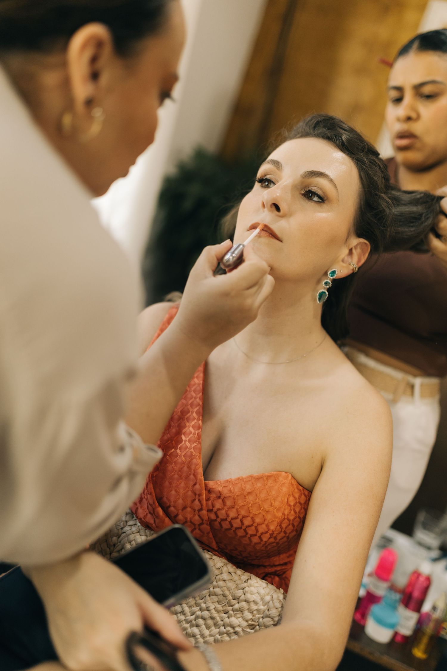 Close-up shots of makeup application during a beauty preparation session.