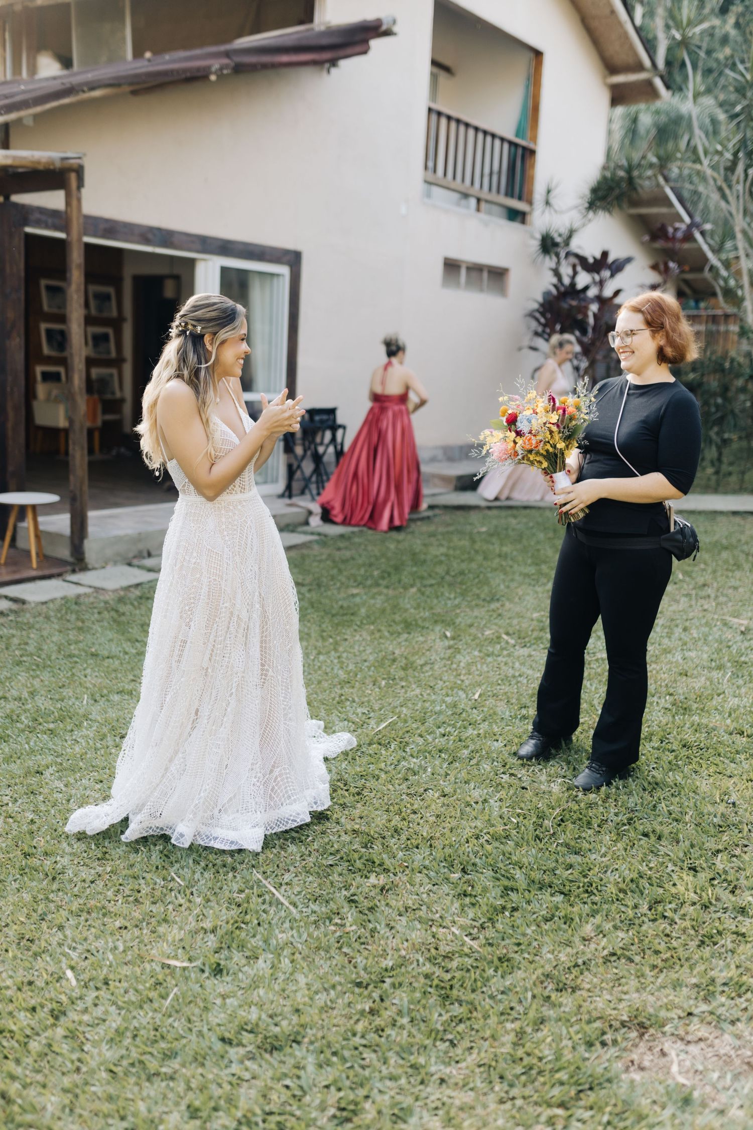 Candid wedding moments captured on a lawn with guests and floral arrangements.