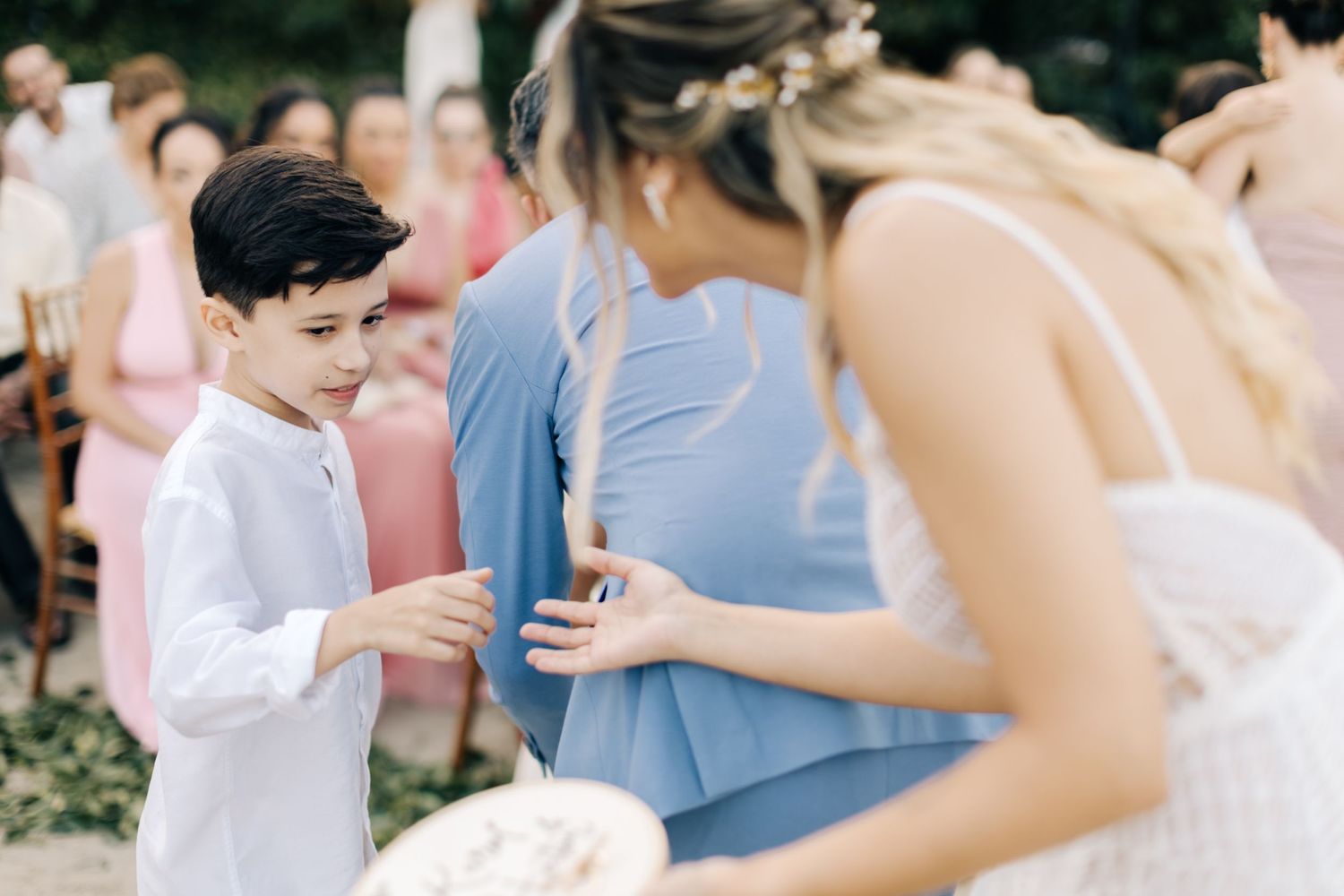 Intimate moment during outdoor wedding celebration with guests.