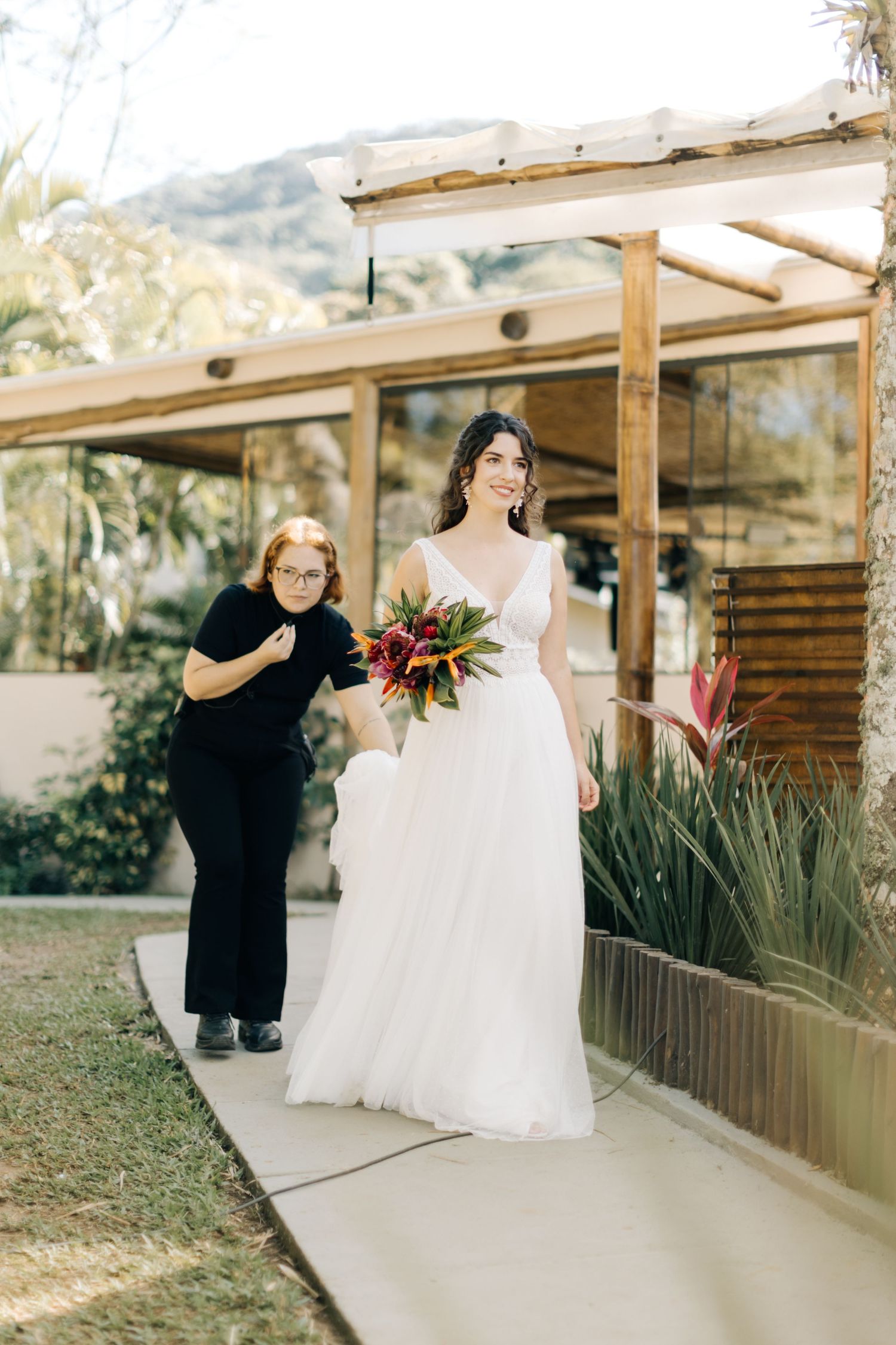 Outdoor wedding photography session at a wooden pavilion with mountain views.