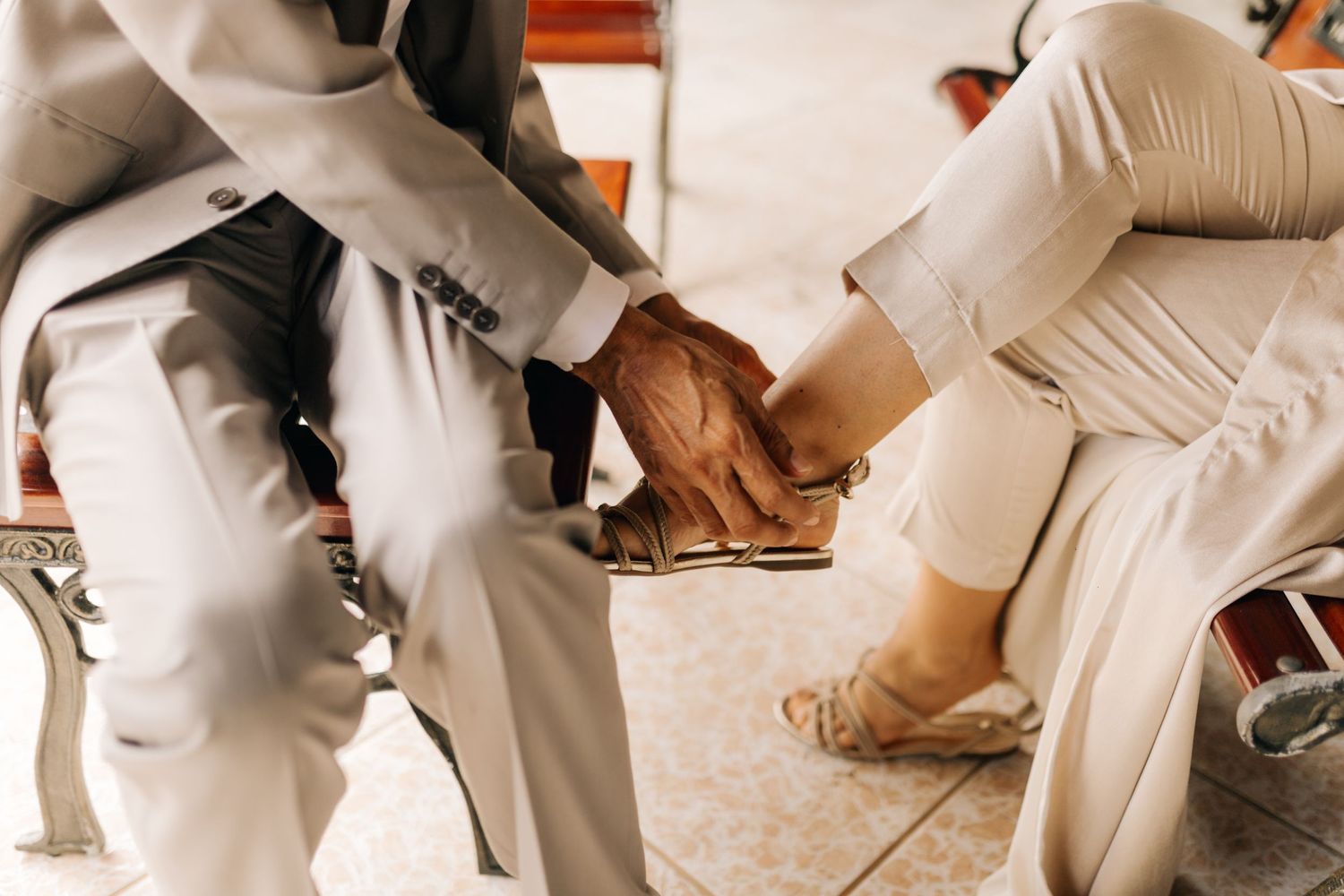 Close up of formal shoes and suit pants during wedding preparation.