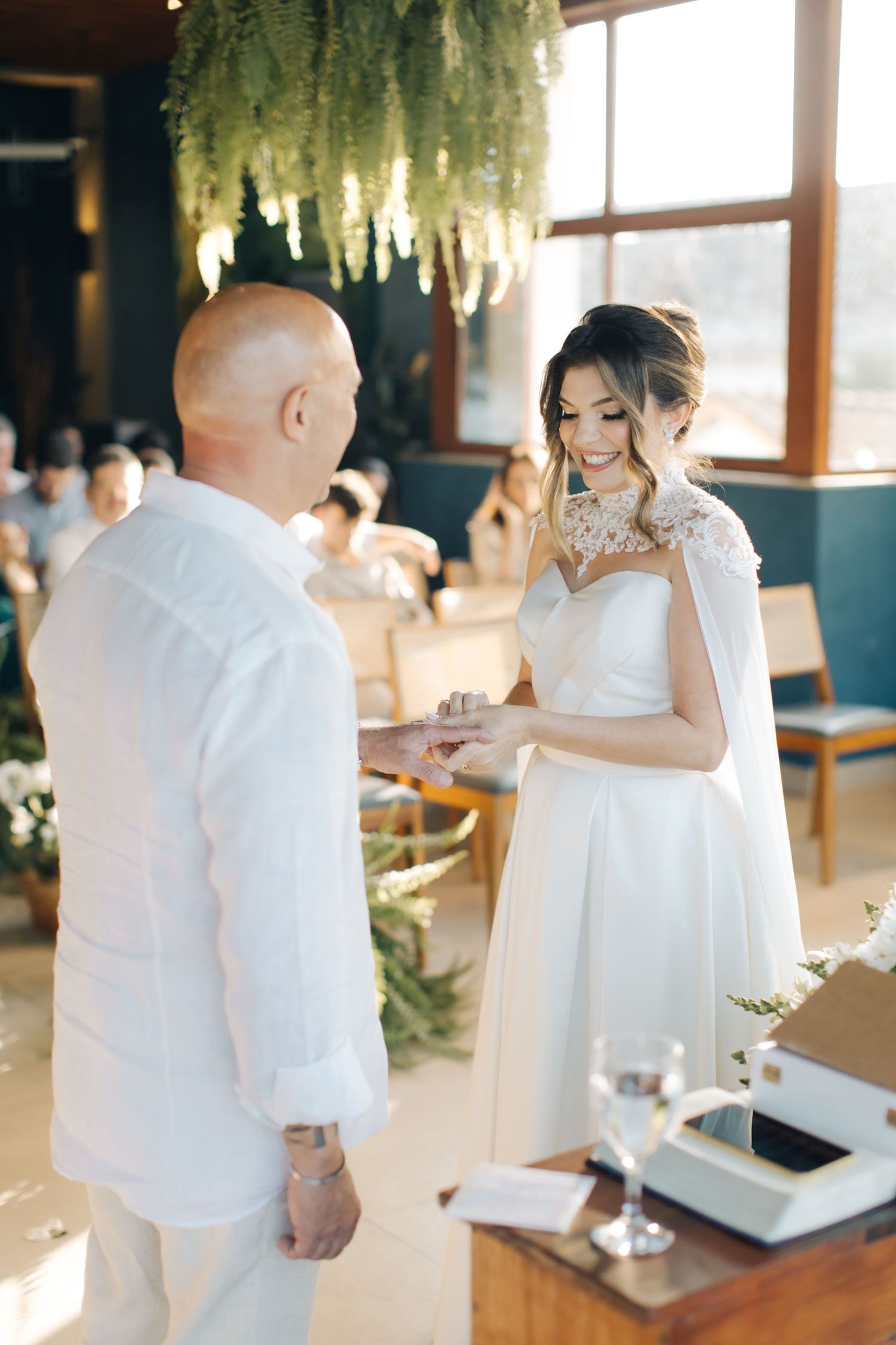 A joyful exchange of rings during an intimate wedding ceremony with elegant decor.