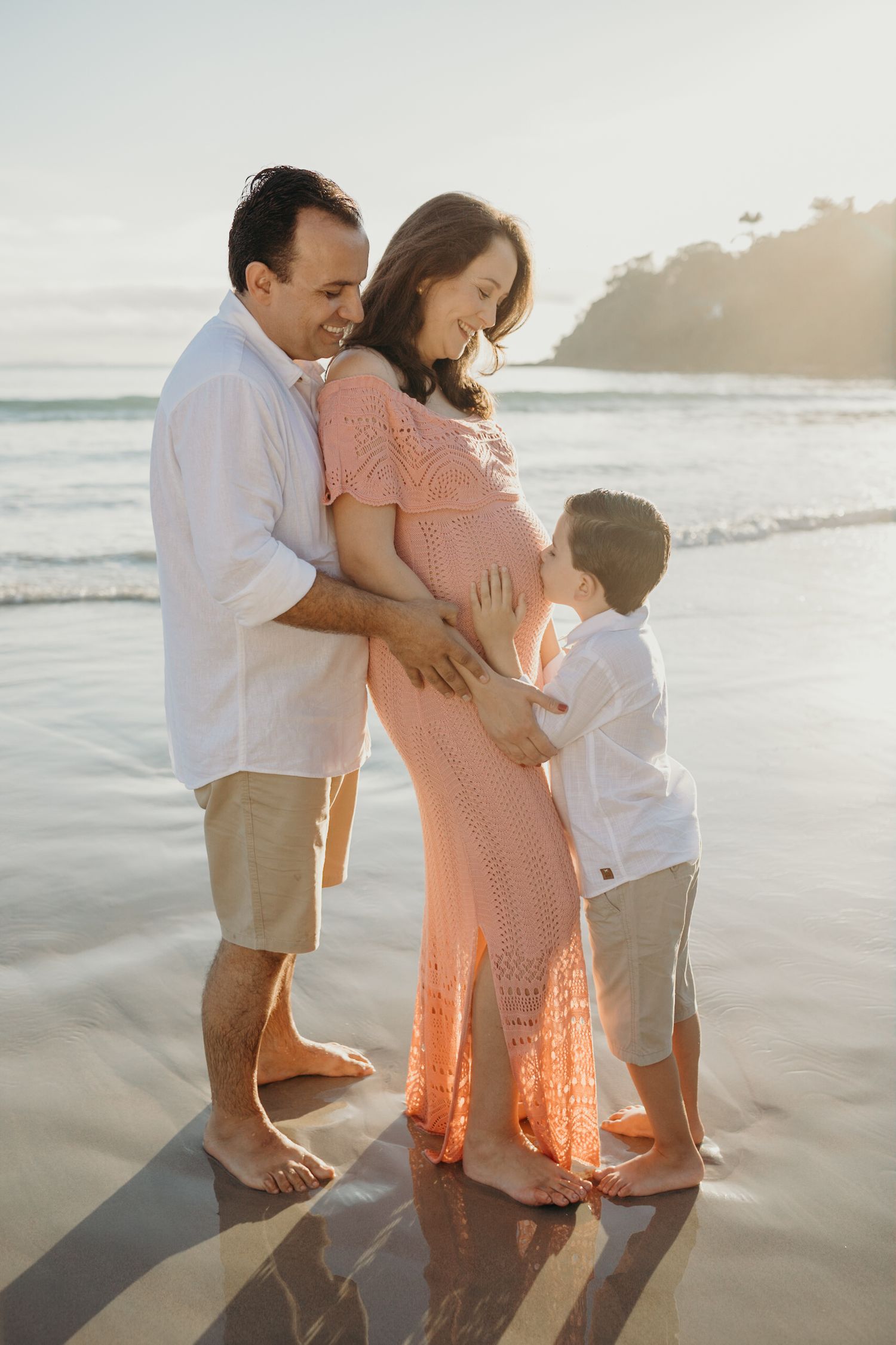 Candid family beach photos showing playful moments during golden hour.