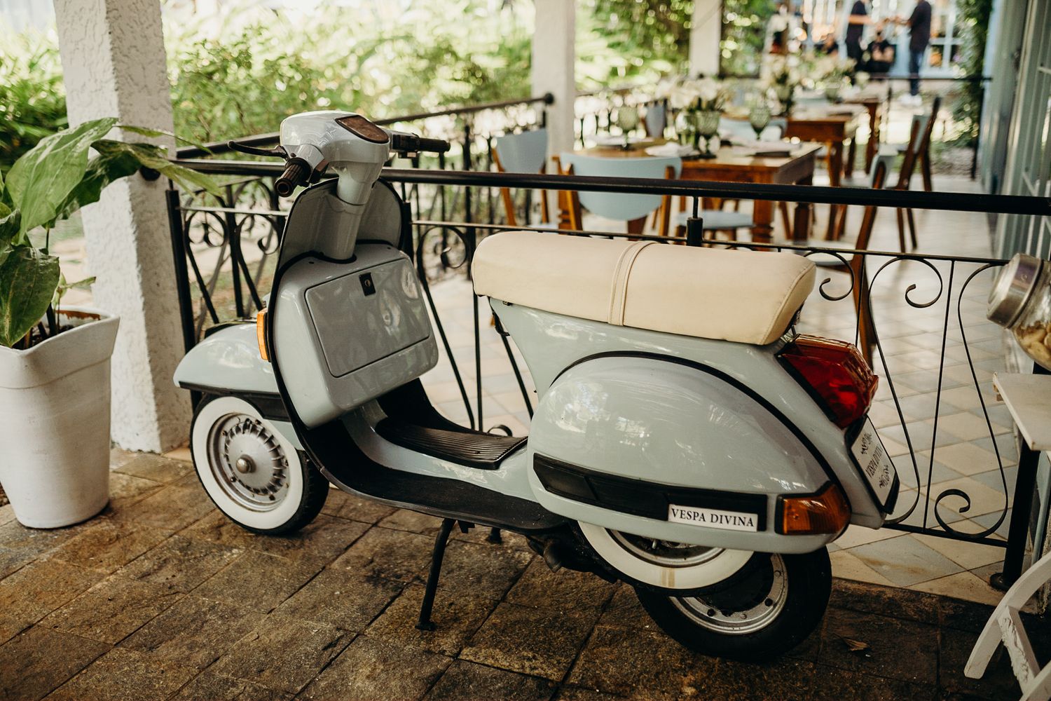Vintage scooters parked outside a restaurant patio creating a retro atmosphere.
