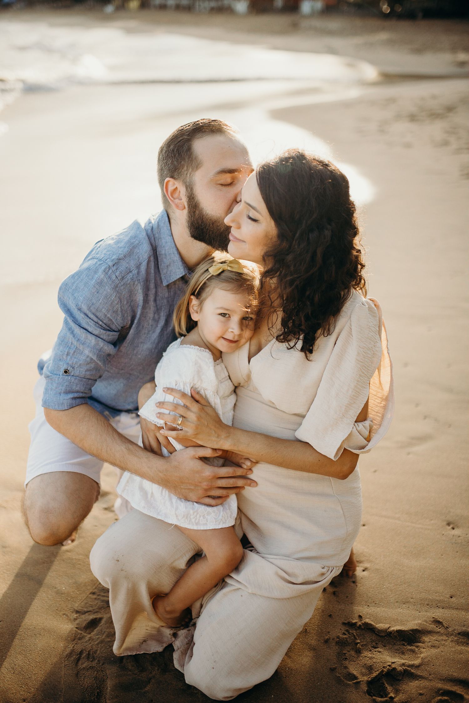 Tender family moments captured during sunset beach photo session.