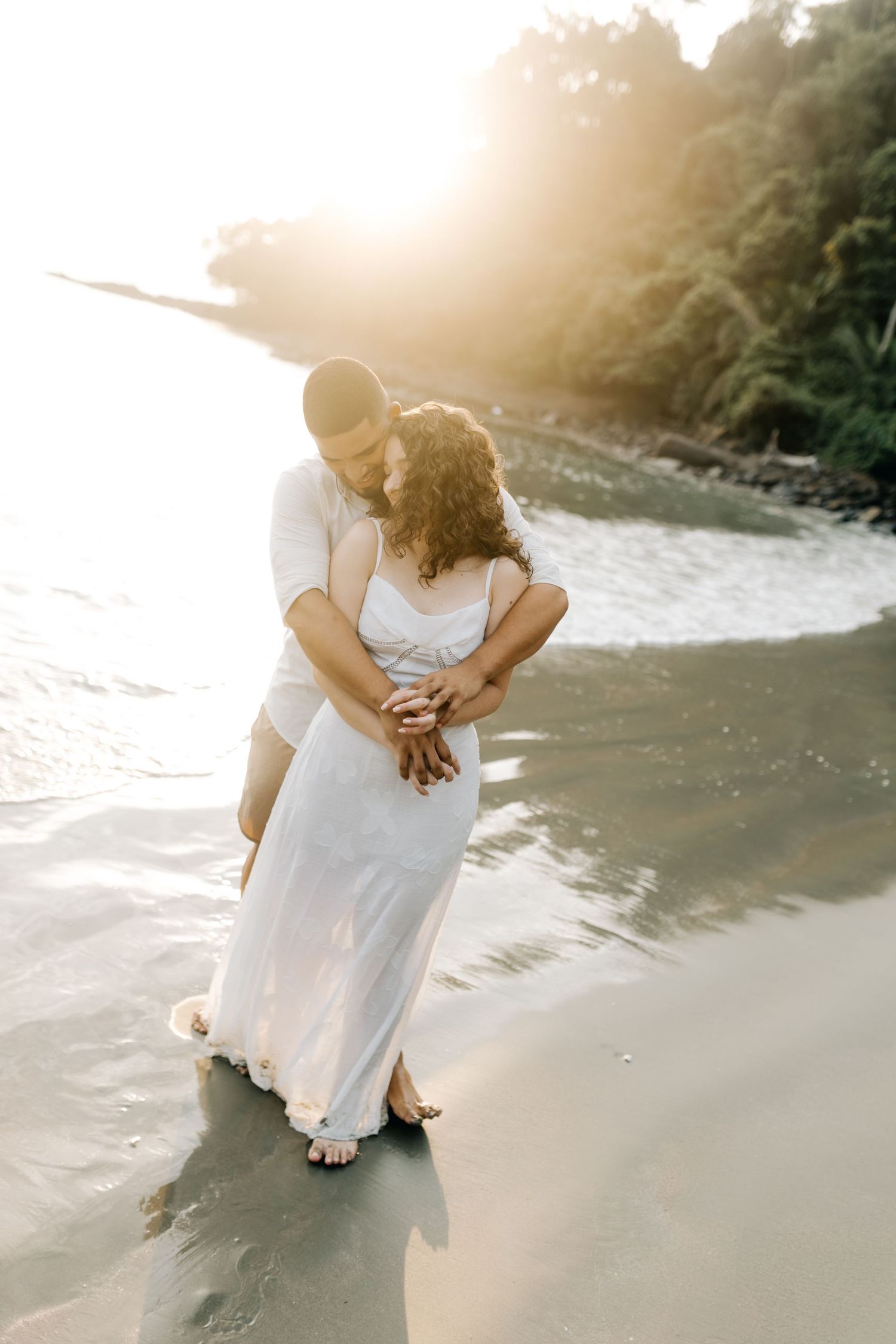 Intimate beach portraits capturing tender moments between a loving couple.