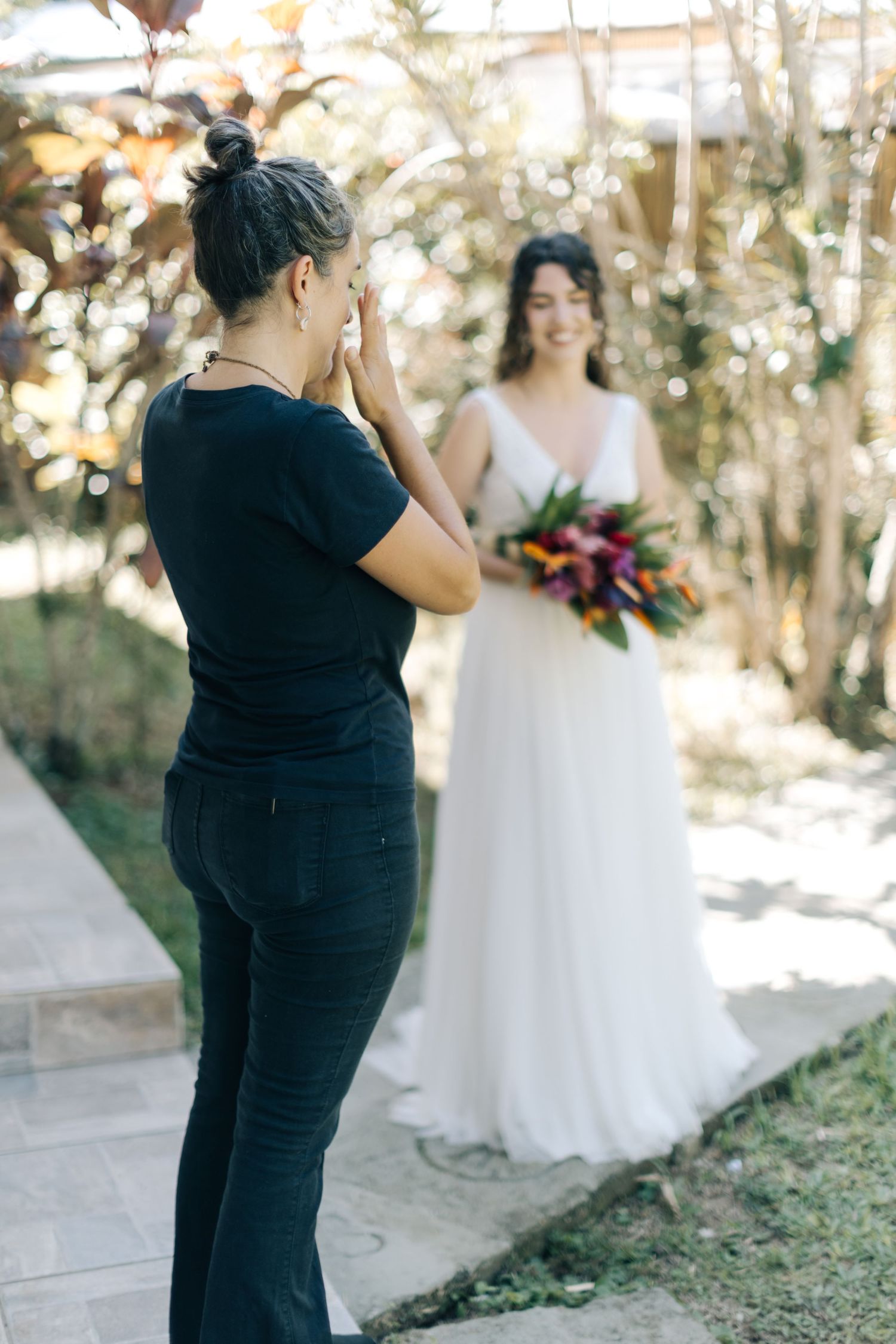 Behind the scenes of a wedding photographer capturing bridal portraits in a garden.