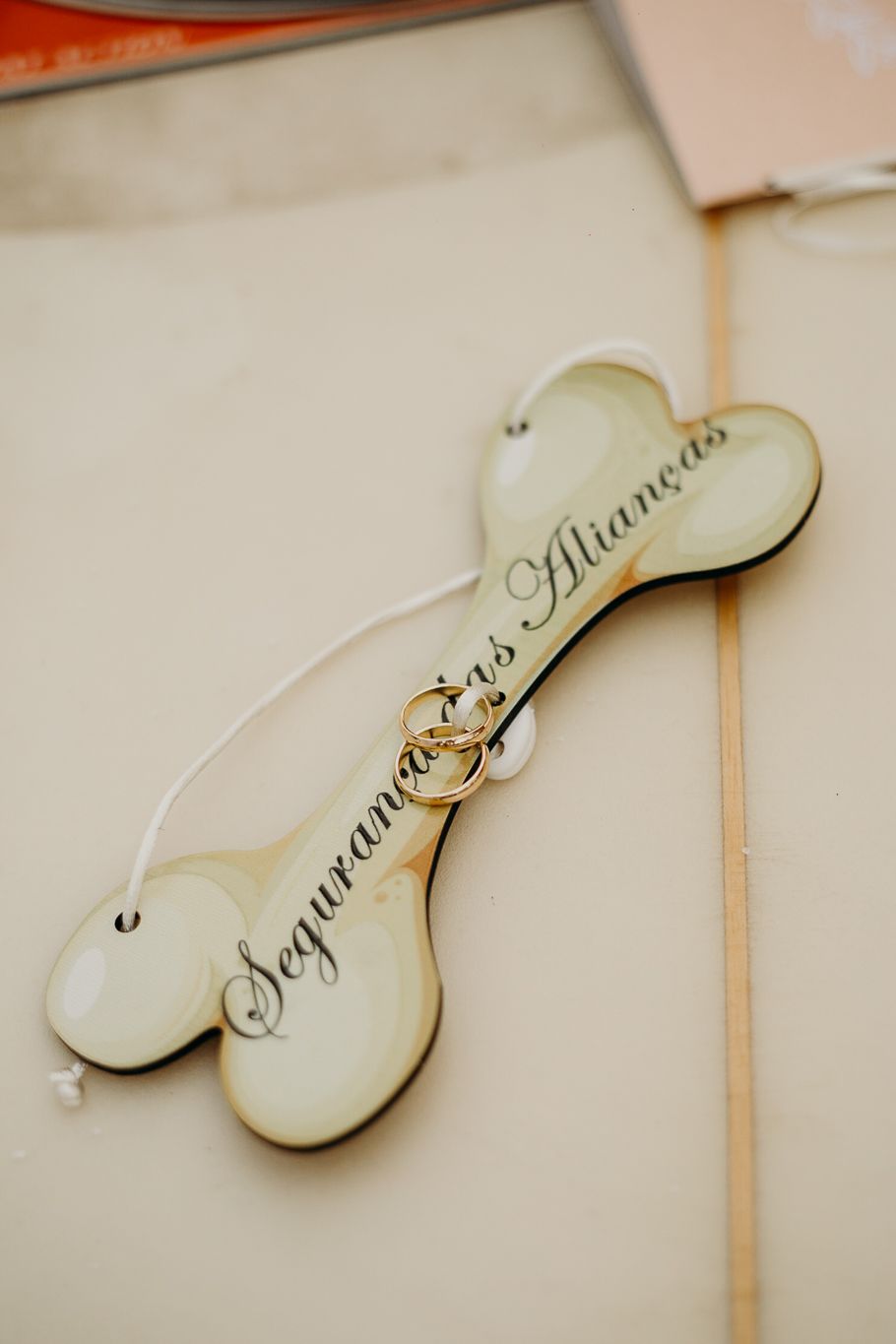 Decorative wooden heart-shaped wedding sign with text in elegant script.