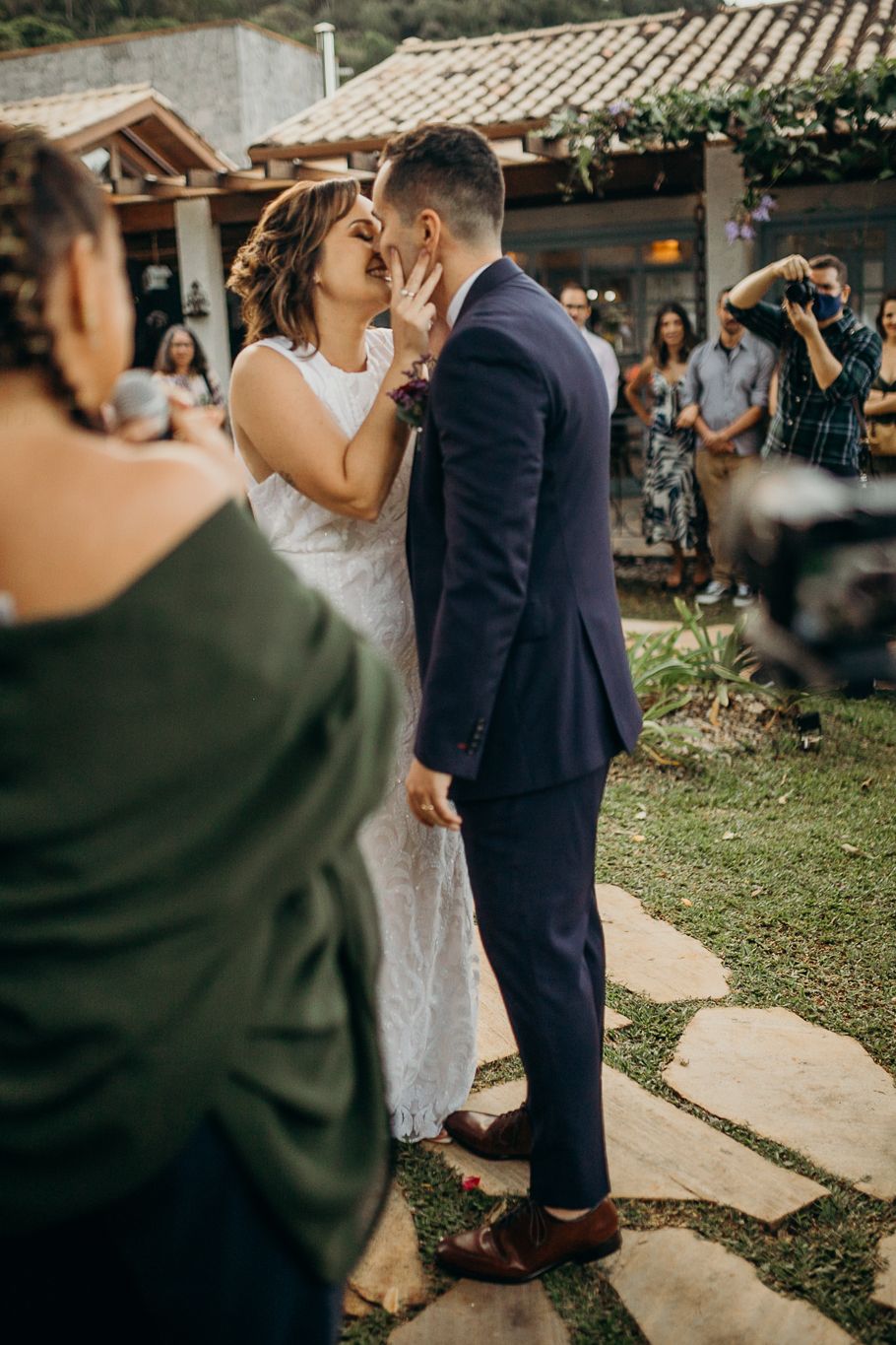 An emotional wedding ceremony moment captured on a stone pathway with mountains in the background.