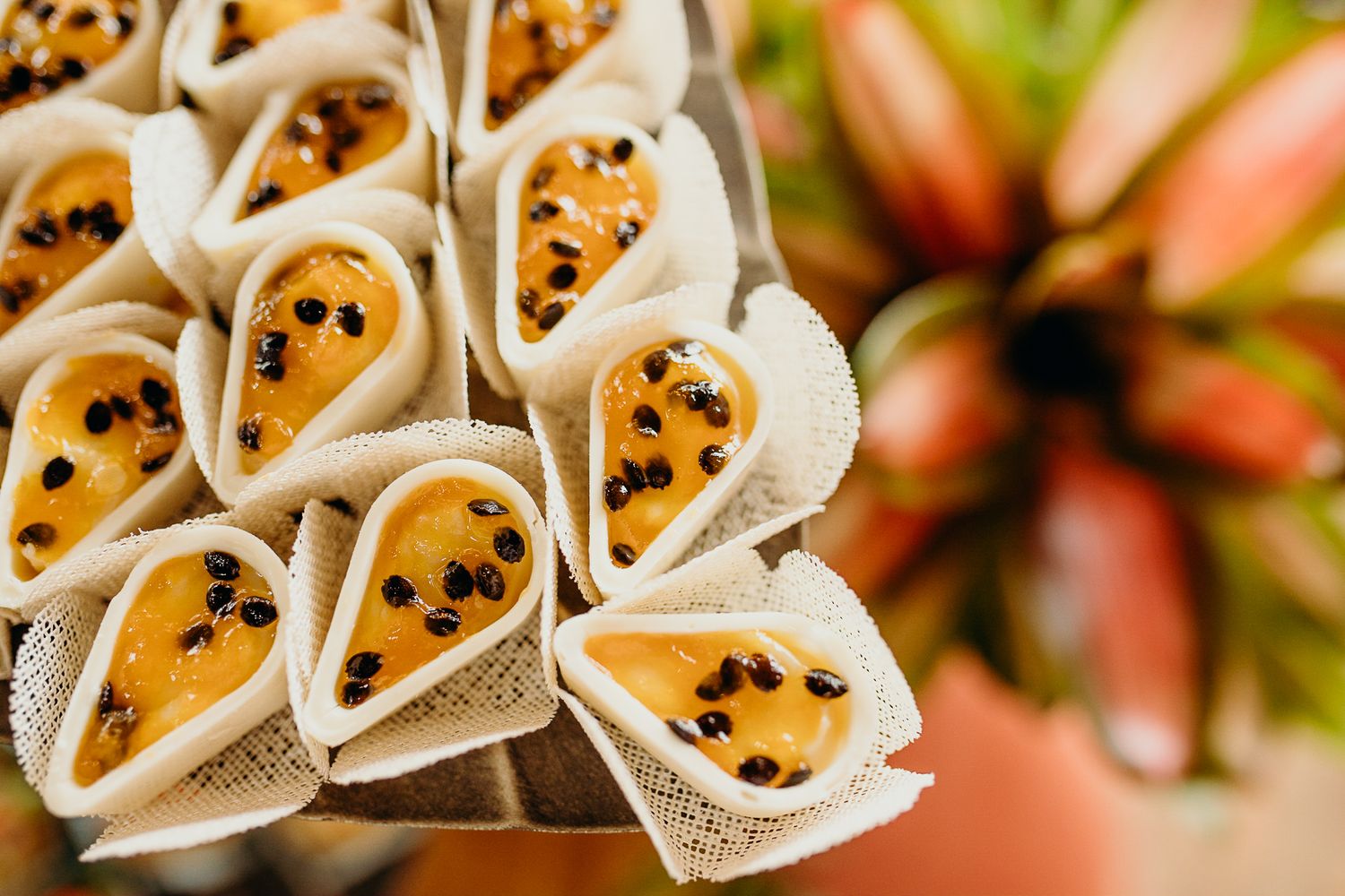 Close-up of decorative appetizer cones arranged in rows at a catered event.