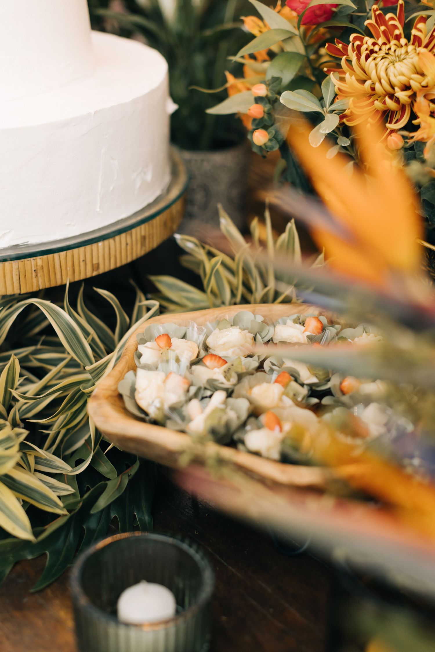Tropical-themed table setting with decorative plants and appetizers.