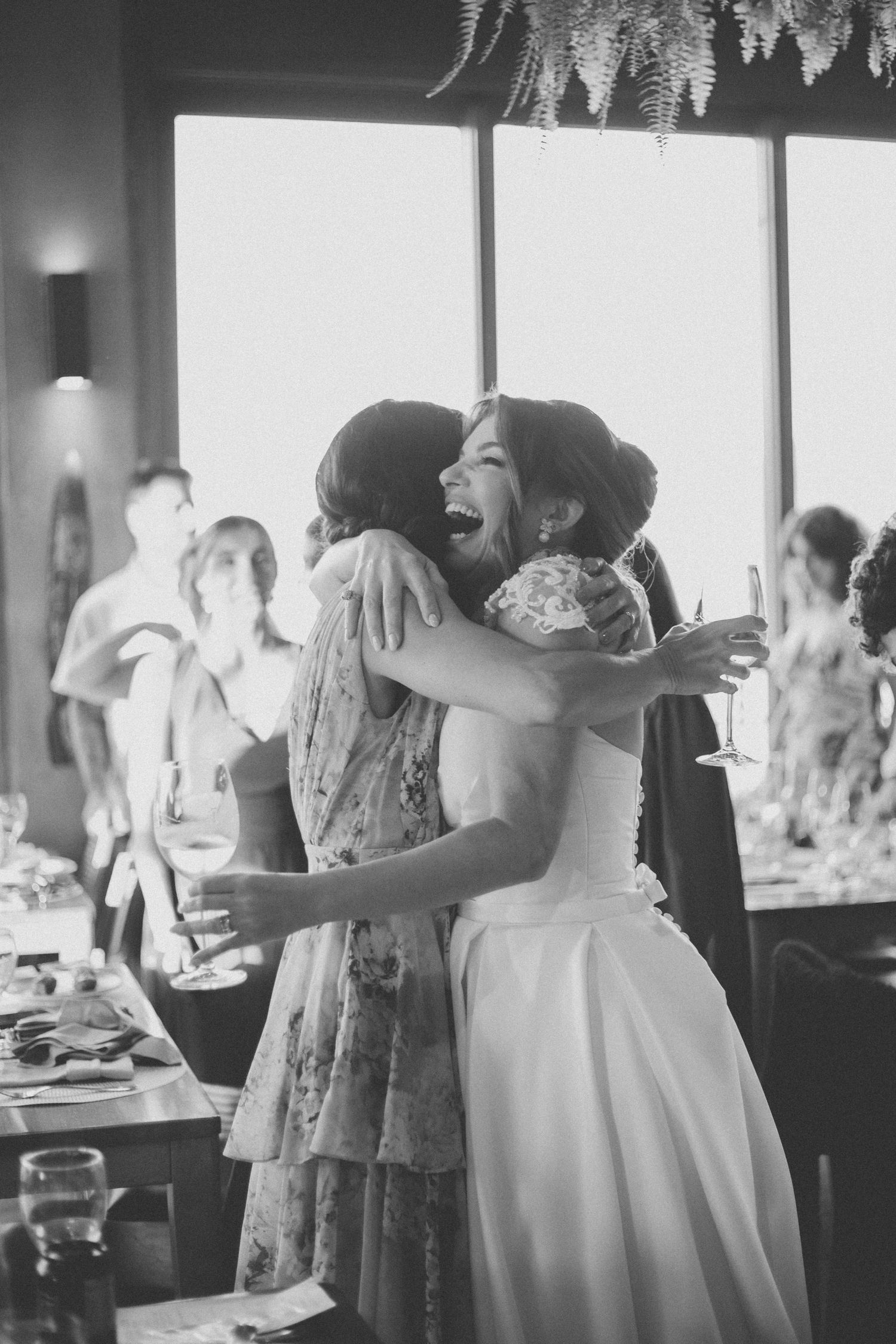 Black and white images showing people dancing and embracing at a wedding reception.