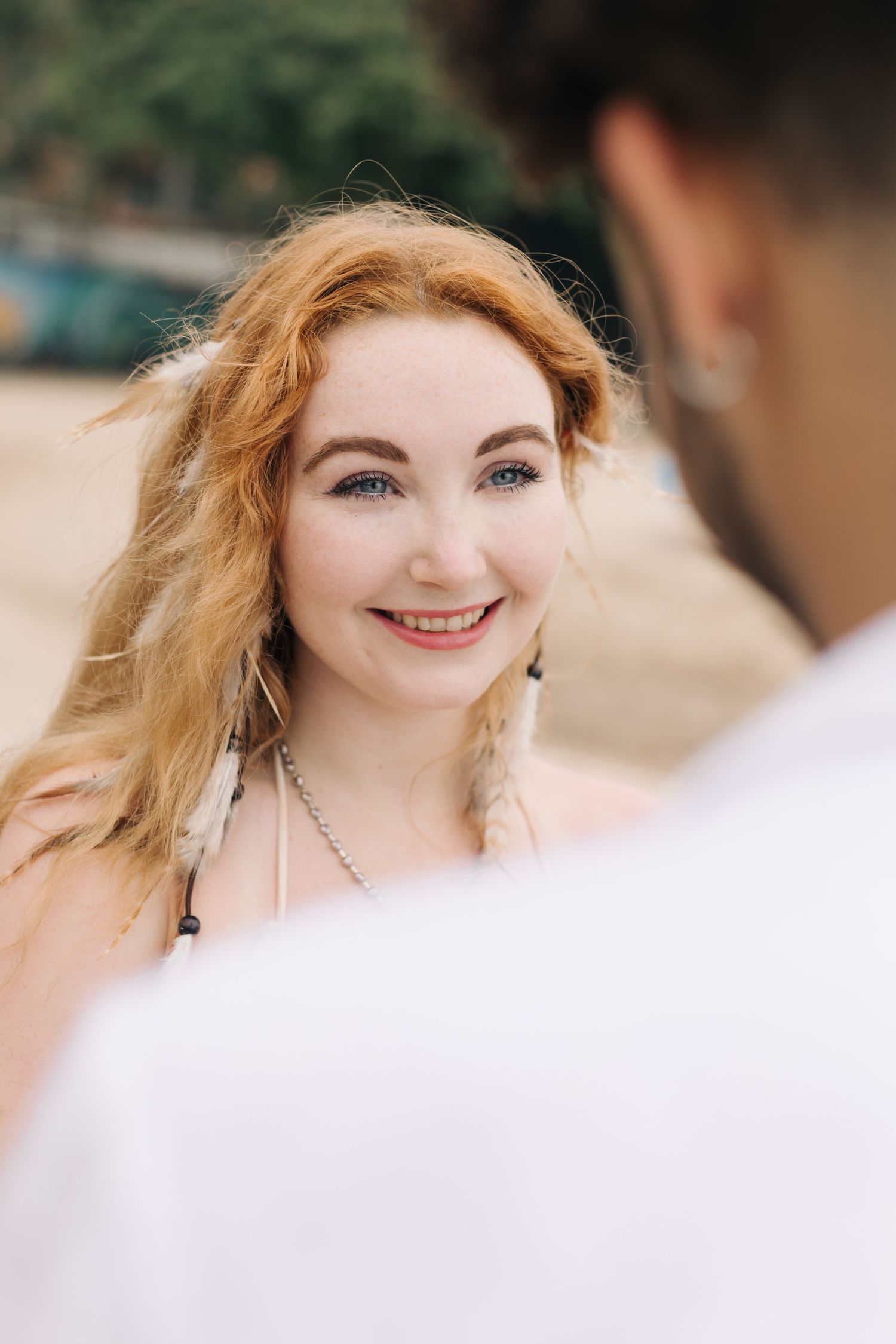A joyful moment captured between two people during what appears to be a beach ceremony.