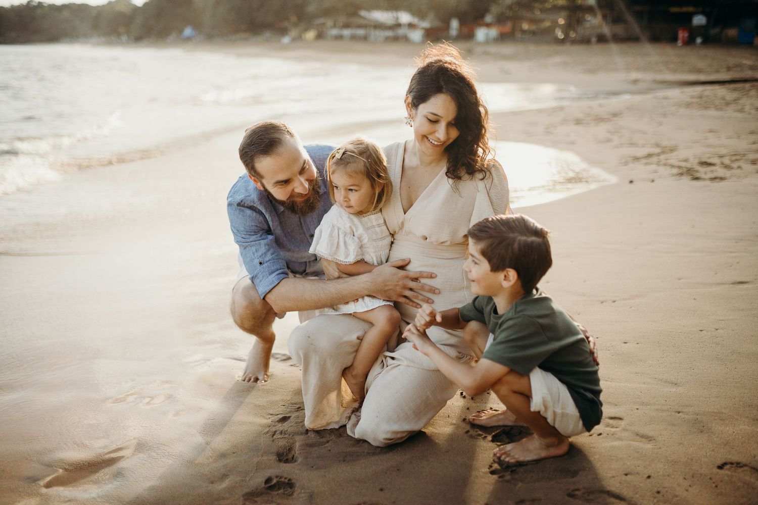 Casual beach family portrait session with natural interactions.