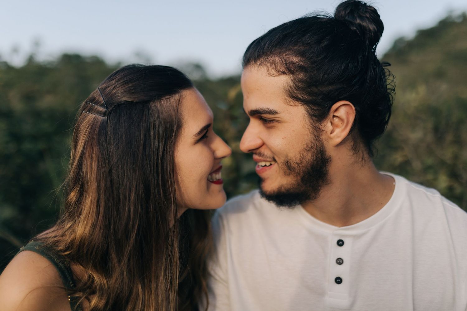 Close-up shot of couple sharing an intimate moment outdoors.