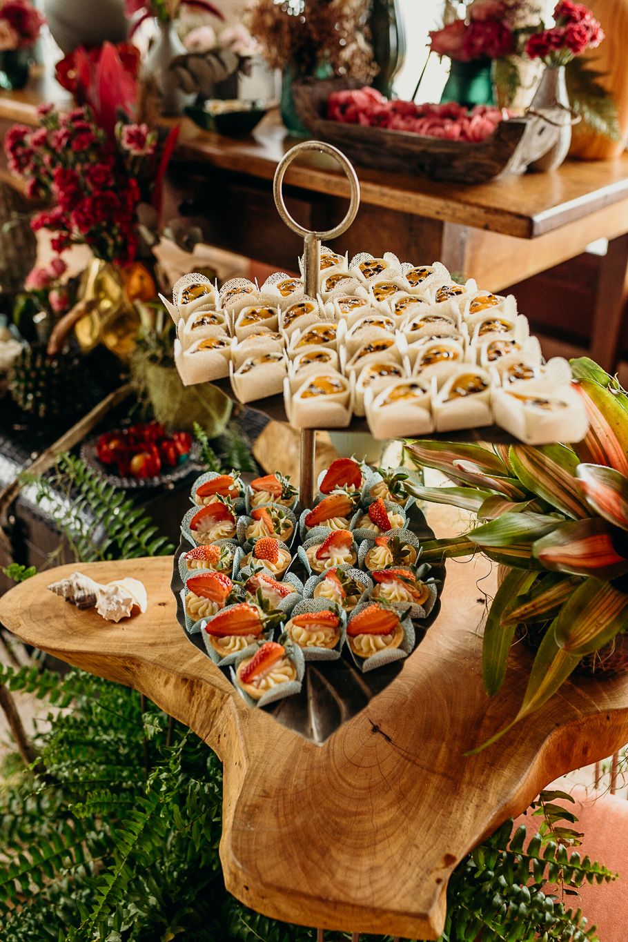 Elegant catering display of appetizers and hors d'oeuvres on wooden serving boards.
