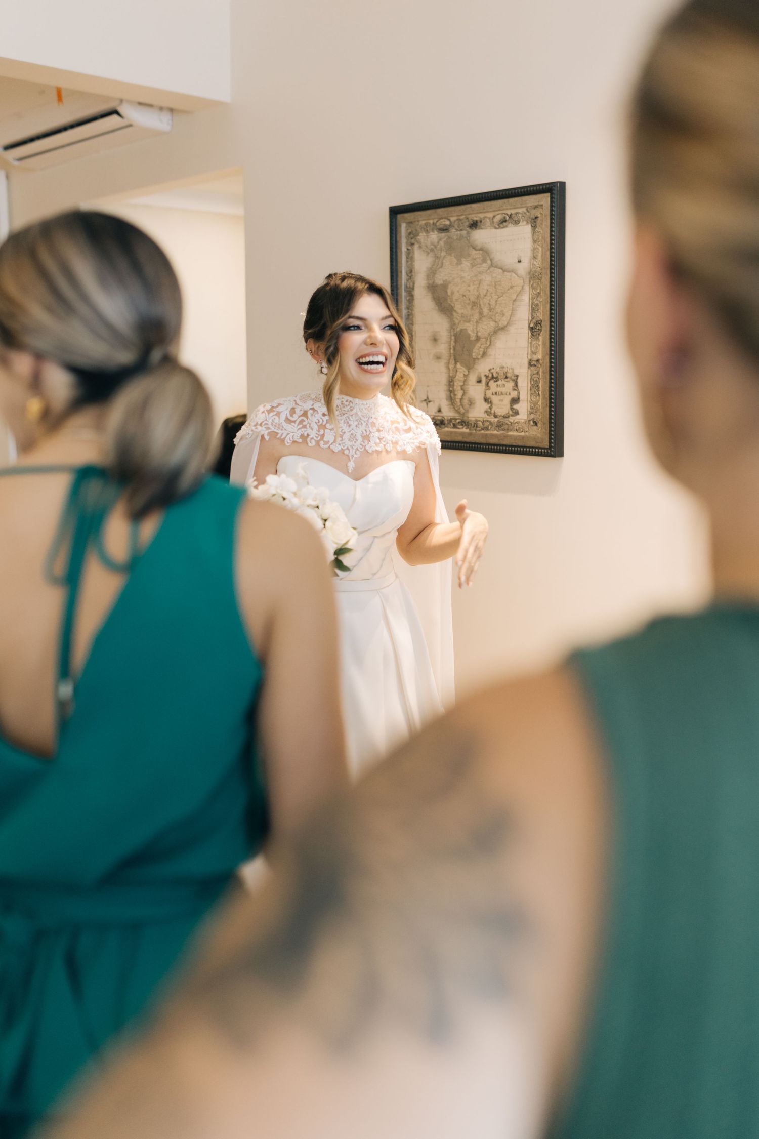 Wedding preparation scene with bridesmaids in teal dresses watching dress reveal.