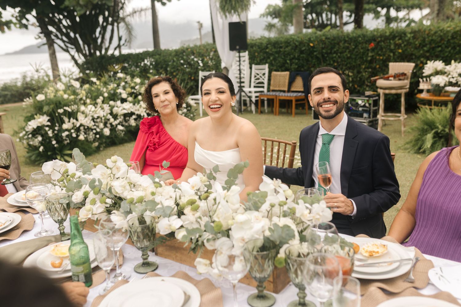 Elegant wedding reception table setup with white floral centerpieces and natural decor.