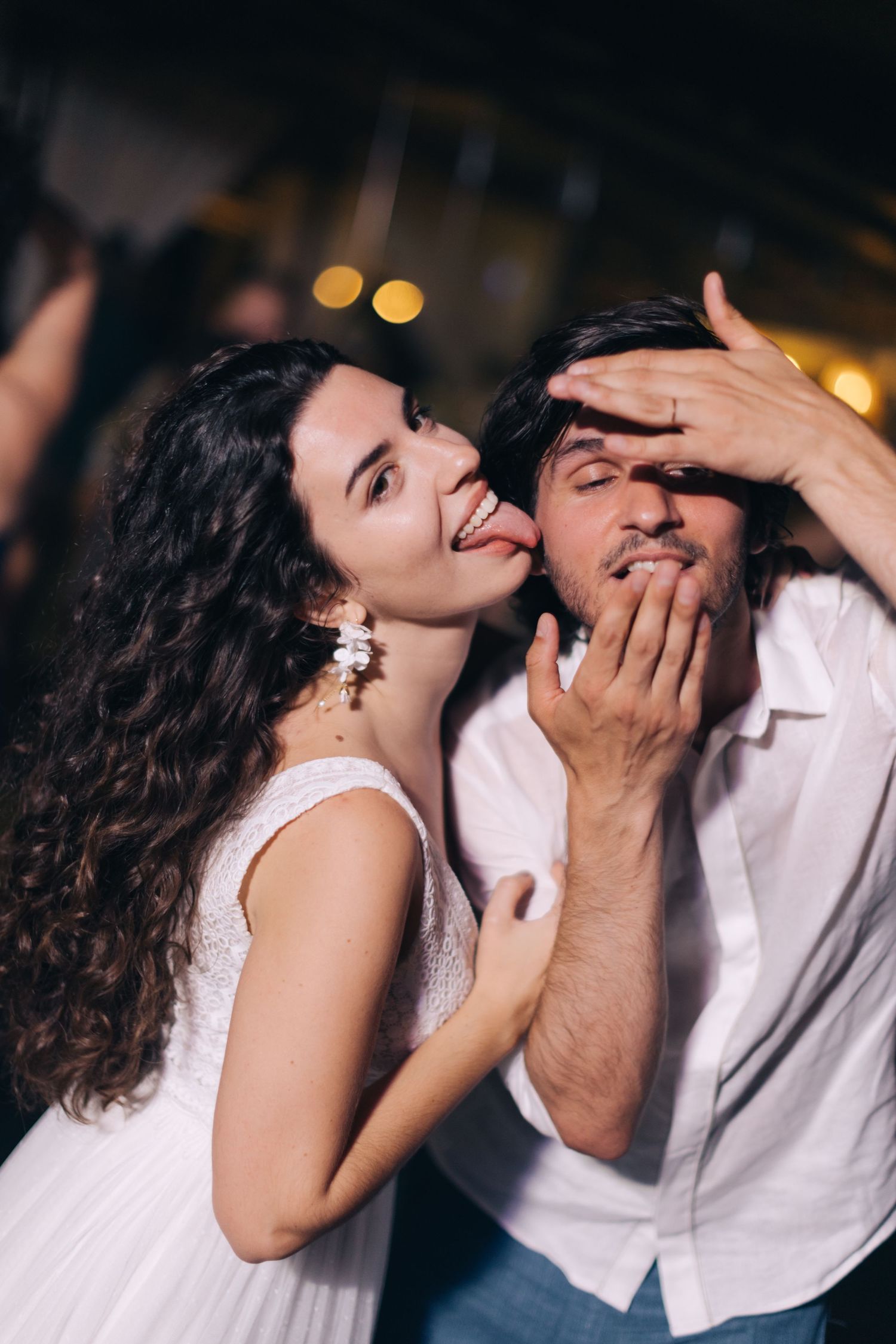 Close-up sequence of joyful laughter and emotional connection between a couple in white attire.