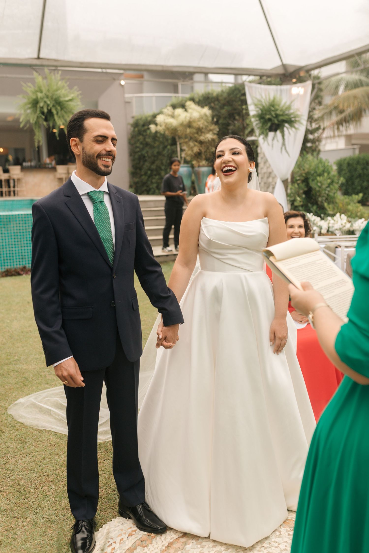 Candid moments from a wedding featuring elegant white and emerald green color scheme.