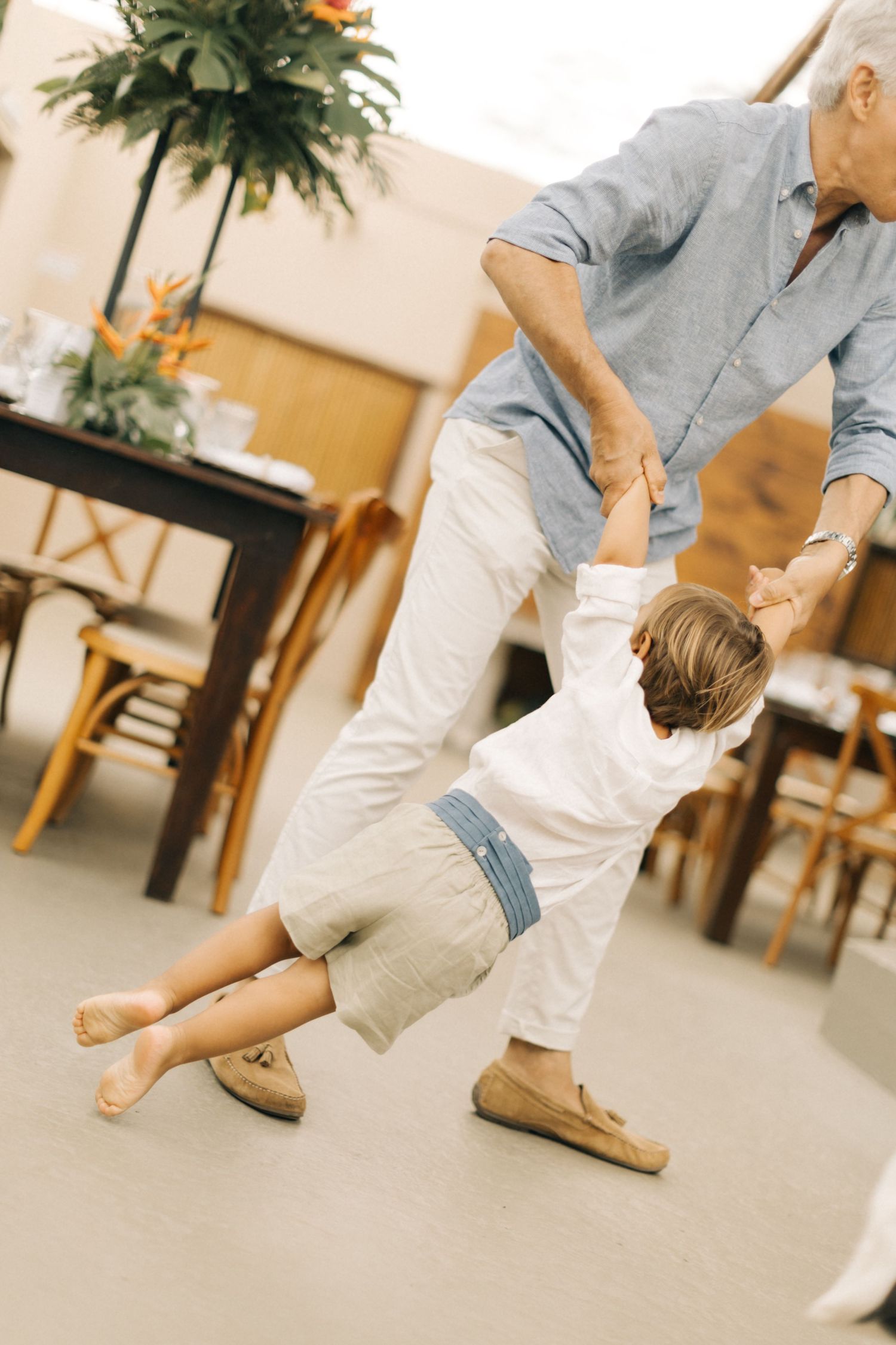 People's feet and legs shown while playing or dancing in a bright indoor space.