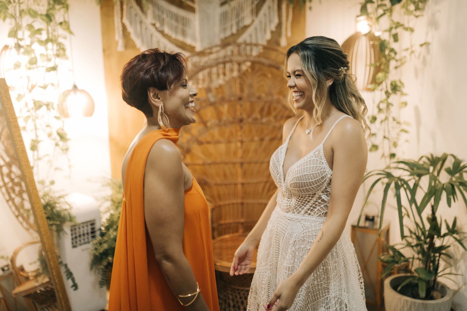 Wedding preparation scene with two attendants sharing a moment together.
