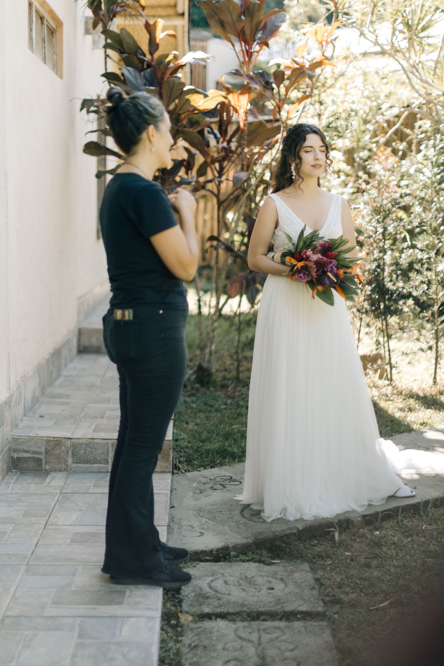 Wedding photography session with floral bouquet in natural outdoor setting.