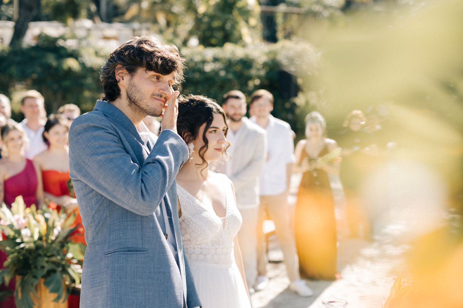Couple enjoying emotional moment during outdoor wedding ceremony.
