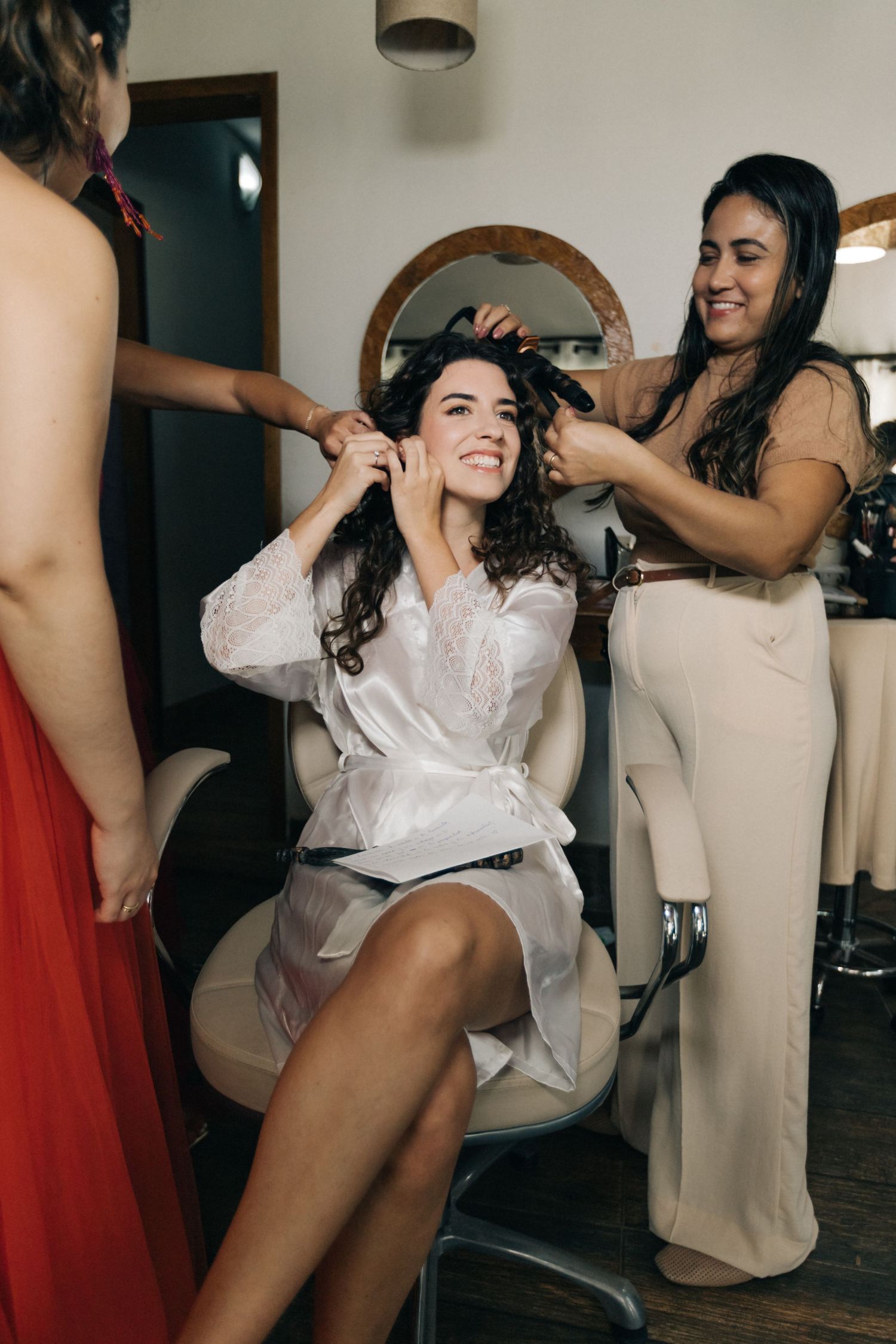 Wedding preparation scene with styling session in bright indoor setting.