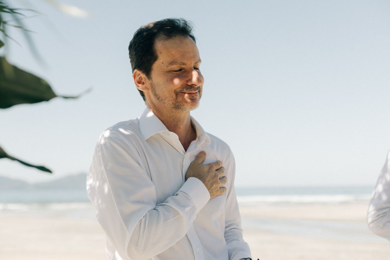 An emotional moment during a beachside wedding ceremony.