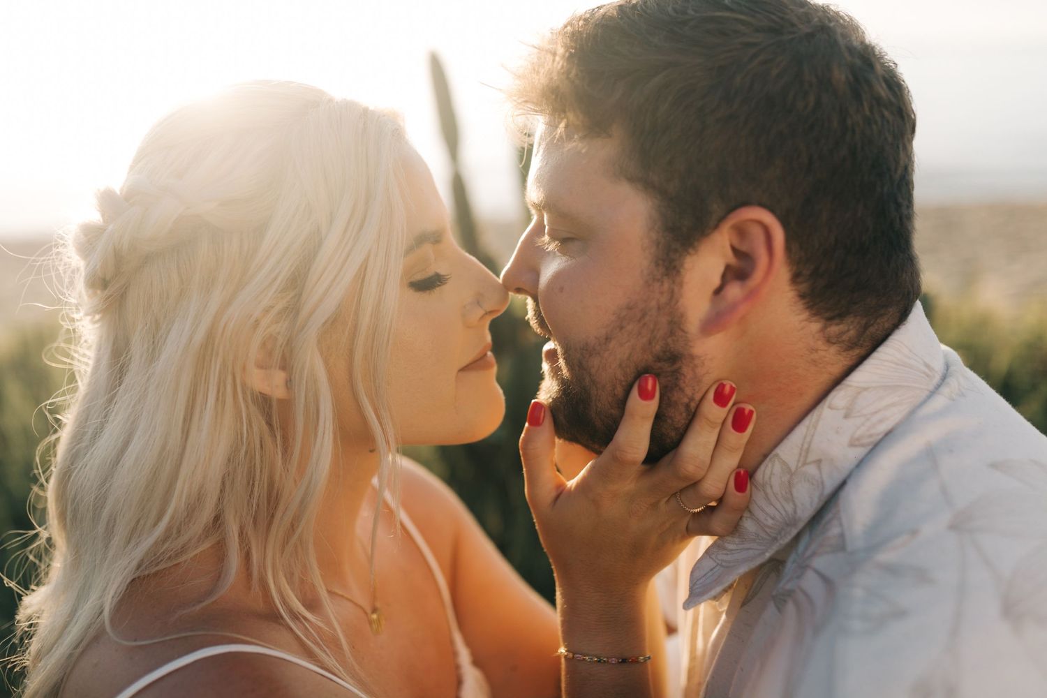 A close-up intimate moment between a couple during golden hour.