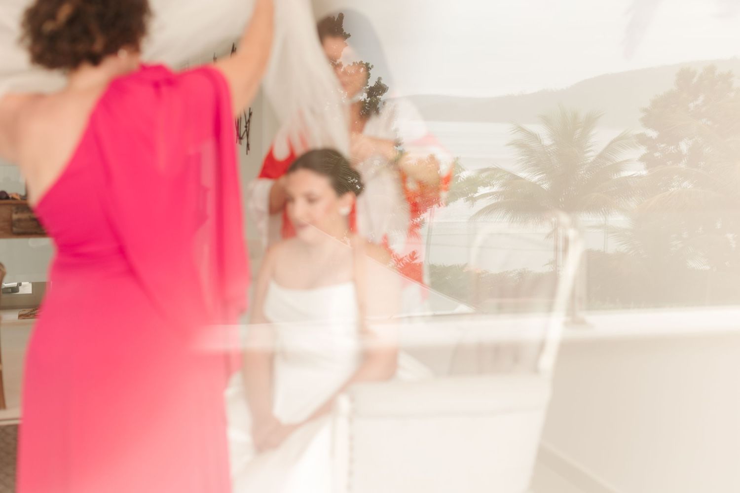 Blurred artistic shot of wedding preparation with splash of bright coral color.
