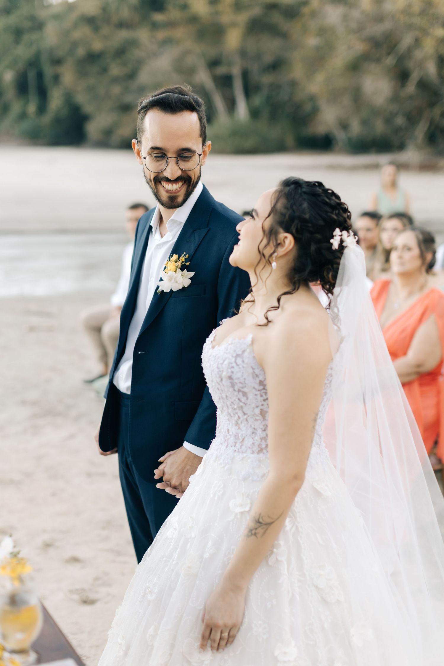 Newlyweds share a happy moment during their beachside wedding ceremony.