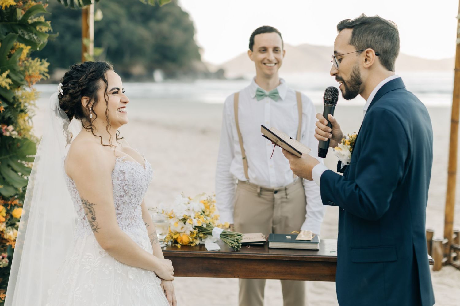 Candid moments between couple during their beach wedding ceremony.