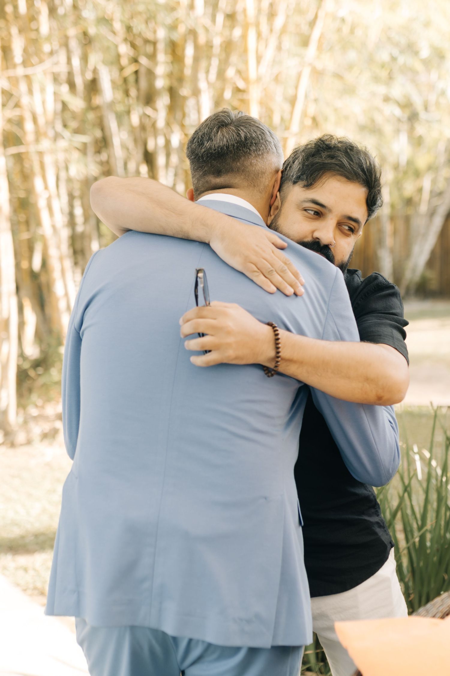 Candid moment showing emotional embrace during special event.