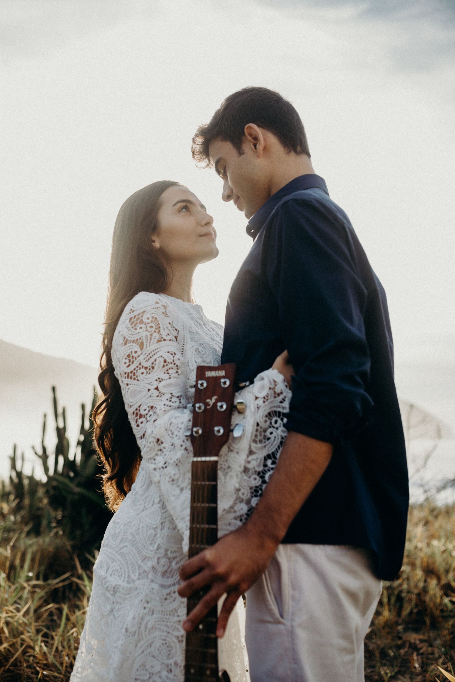 A tender moment captured between a couple with an acoustic guitar during their engagement shoot.