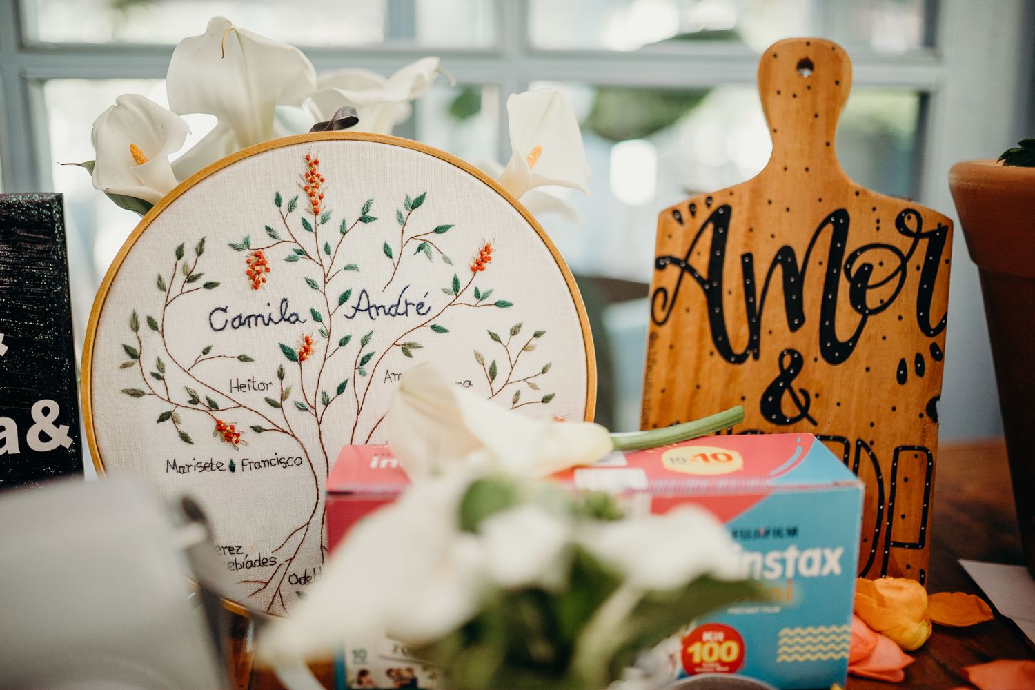 Wedding decor featuring embroidery hoop art and wooden signs with floral designs.