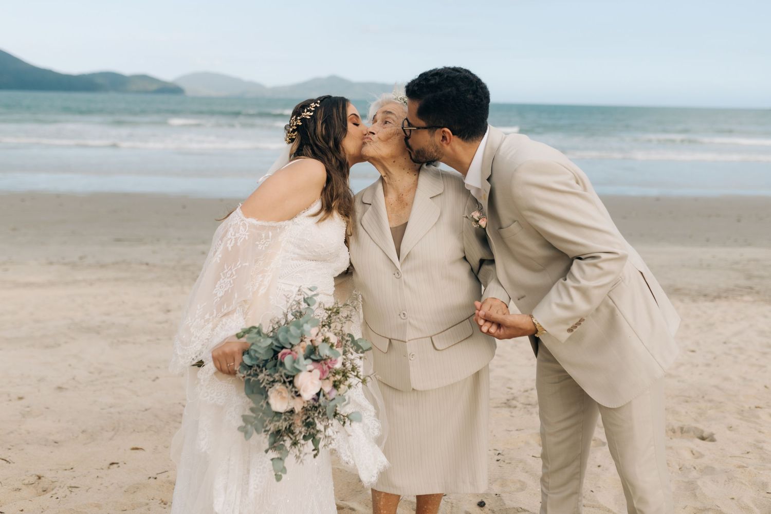 Sweet candid moment captured during beach wedding photo session.