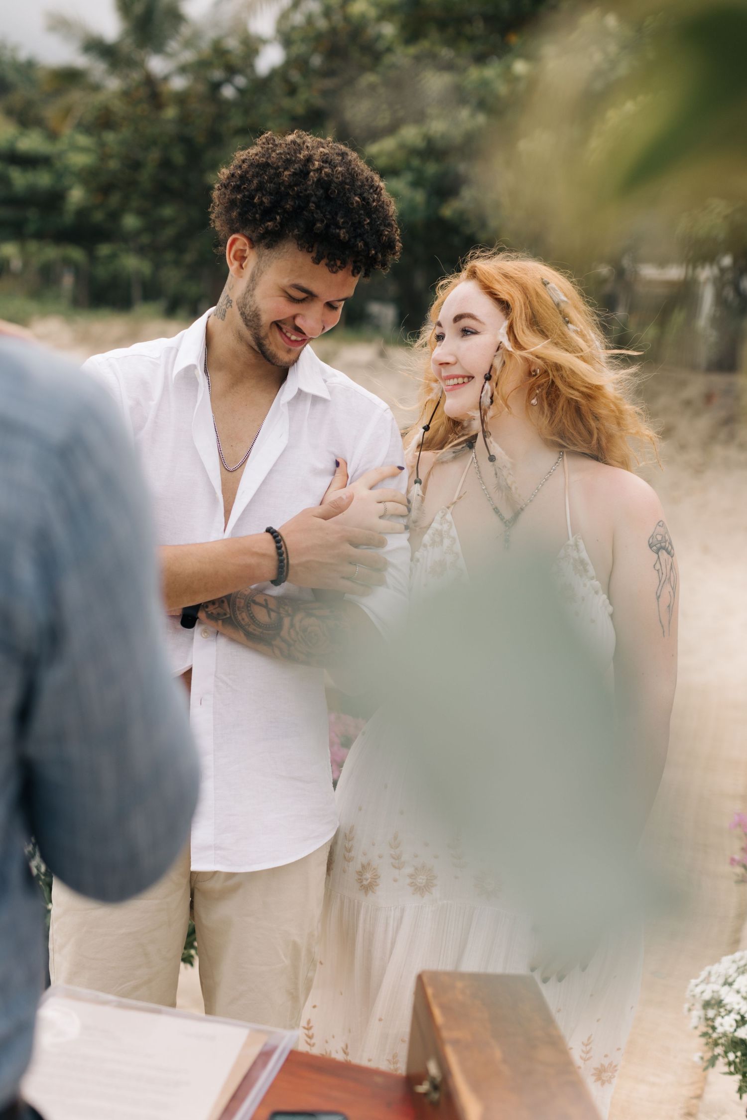 Happy couple exchanging vows at an intimate beach wedding ceremony.