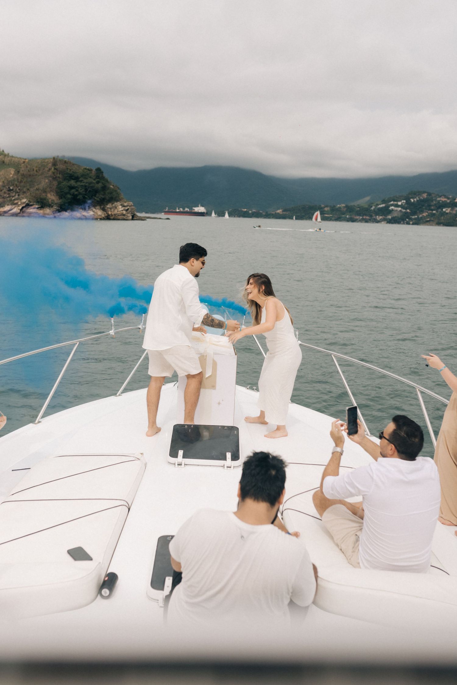 Emotional celebration moment captured on a yacht with scenic harbor views.