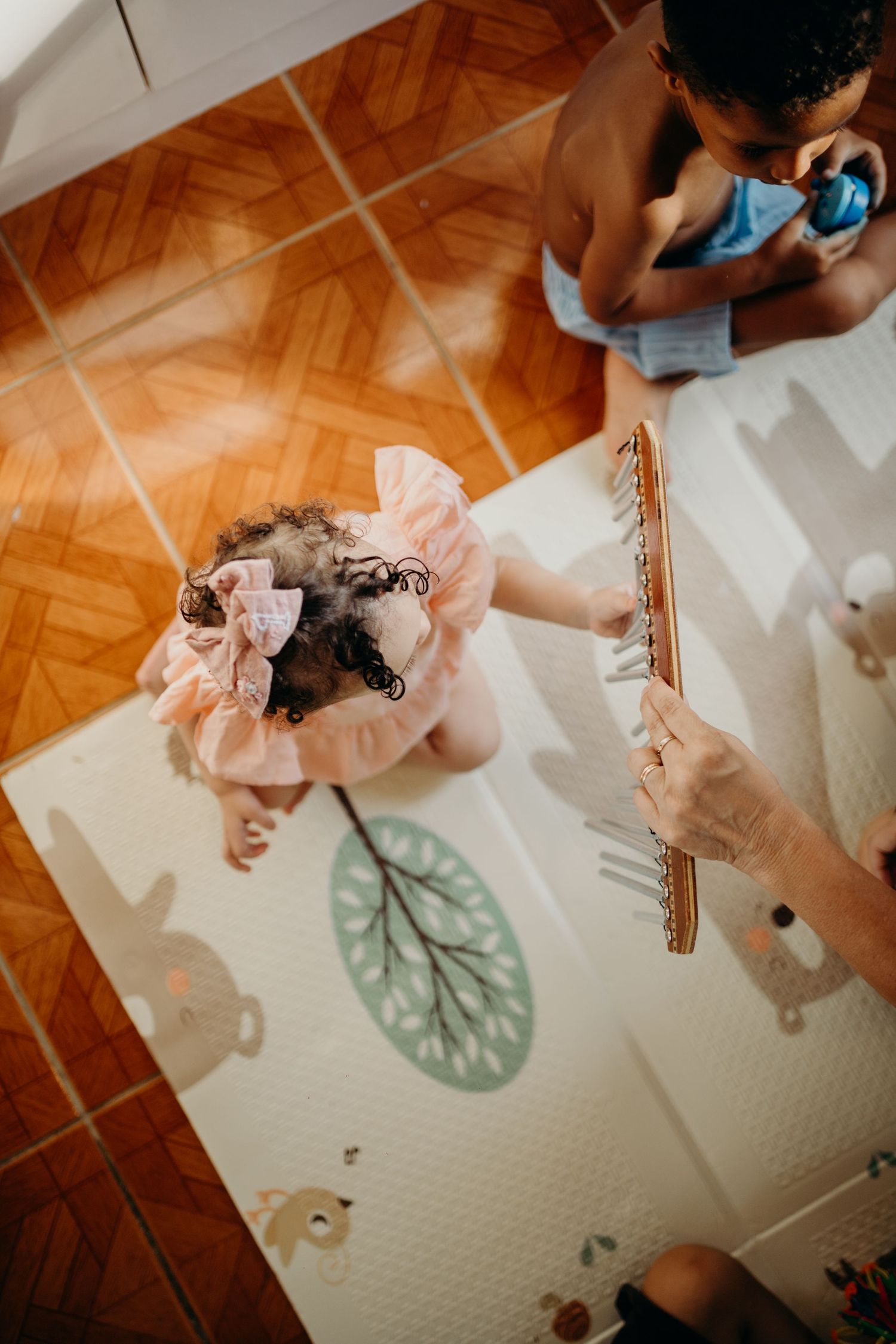 Overhead view of musical performance with decorative floor mat and instruments.