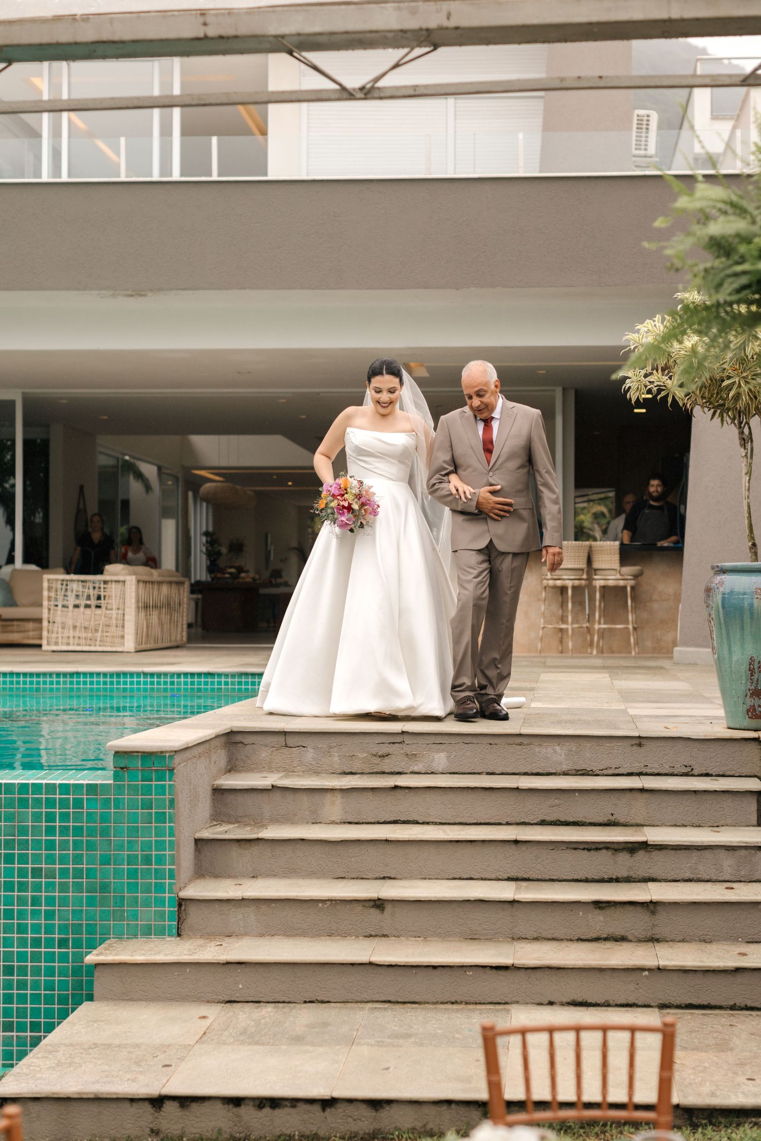Wedding ceremony setup with concrete steps and turquoise accents at an outdoor venue.