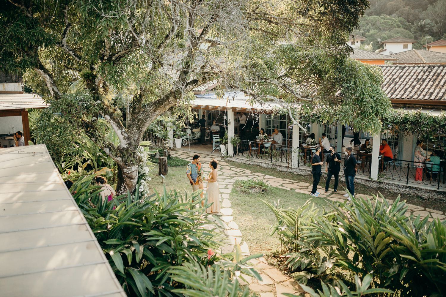 Outdoor garden venue with stone pathways and tropical landscaping.