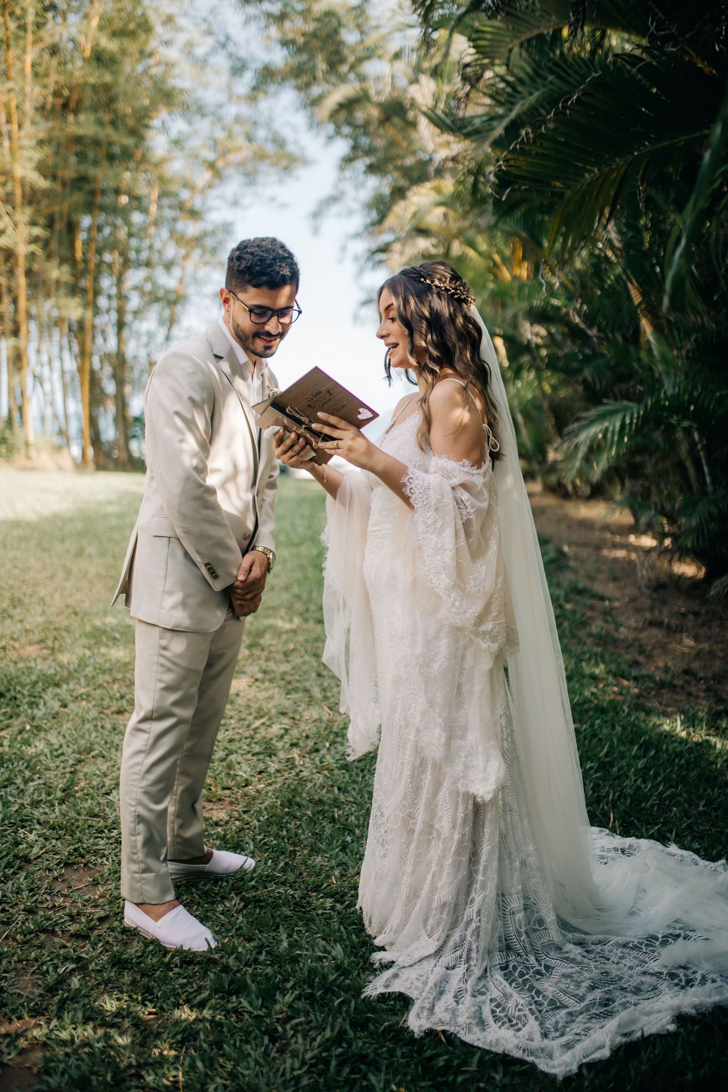 Couple reading from a book during their intimate garden wedding ceremony.